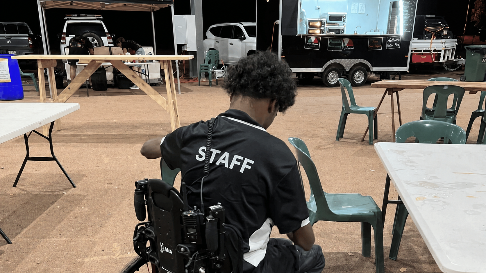 NDIS participant in a wheelchair working as security at a local Darwin community event