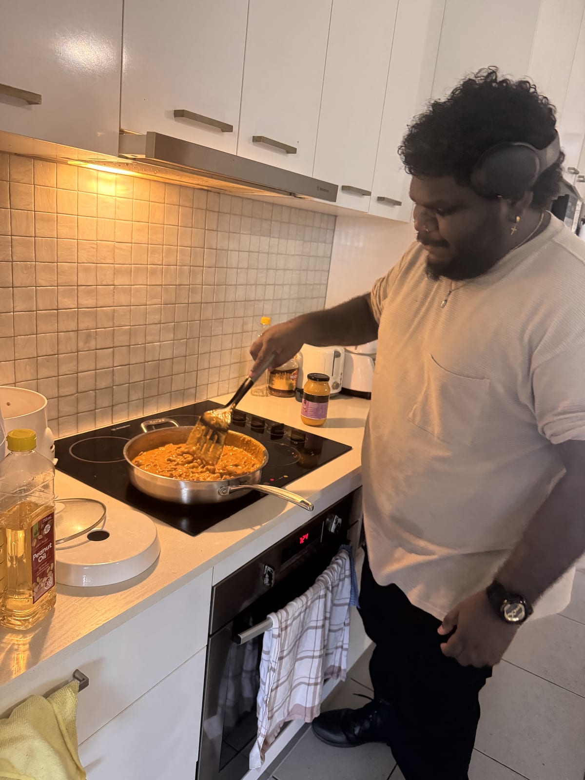 Participant cooking a meal at home with daily living support in Darwin