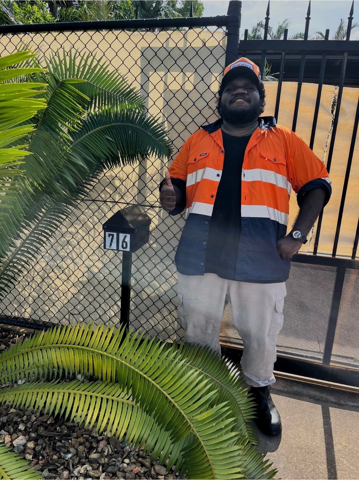 Northern Purpose participant in a hi-vis work shirt outside a Darwin home